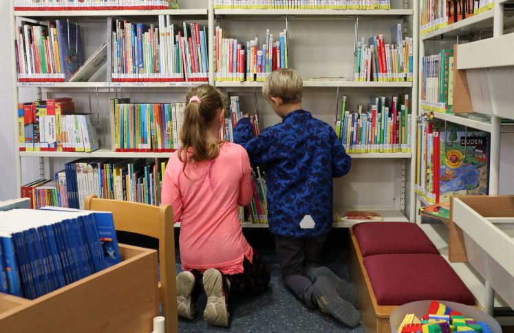 Kinder vor einem Bücherregal