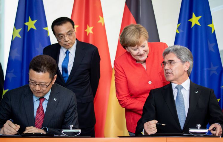 Bundeskanzlerin Angela Merkel (CDU) und Chinas Ministerpräsident Li Keqiang stehen bei der Zeichnungszeremonie bei den 5. deutsch-chinesischen Regierungskonsultationen hinter Joe Kaeser (2.vr), Vorstandsvorsitzender der Siemens AG und dem Vorsitzenden der State Power Investment, Gian Zhimin.