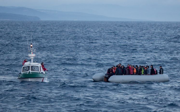 Flüchtlingsboot und Schiff von der Seenotrettung