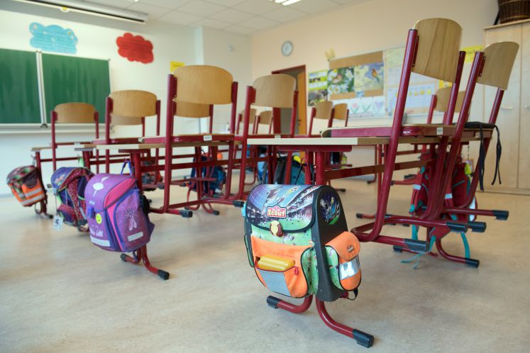  Schulranzen hängen in der Oberschule Ralbitz in einem Klassenzimmer an den Tischen. 