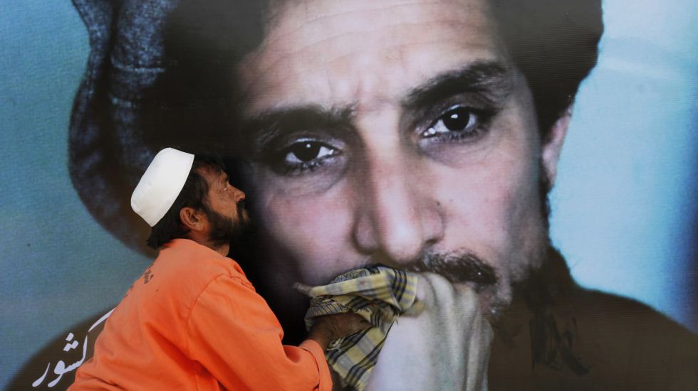 Ein Arbeiter reinigt ein übergroßes Bild des afghanischen Rebellenführers Ahmad Shah Massoud