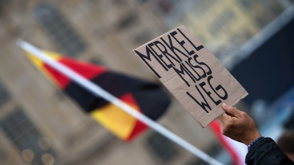 Plakat von Pegida Demonstranten am Tag der Deutschen Einheit mit dem Schriftzug "Merkel muss weg"