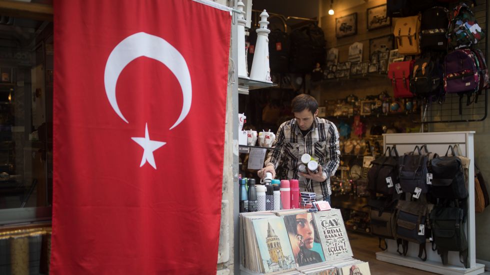 Türkischer Händler in Istanbul vor einer türkischen Flagge