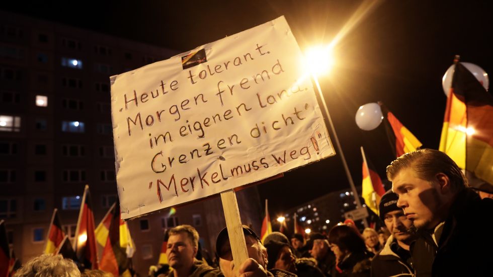 Anhänger der Alternative für Deutschland (AFD) demonstrieren mit einem Plakat "Heute tolerant. Morgen fremd im eigenen Land. Grenzen dicht. Merkel muss weg!" am 24.02.2016 in Erfurt (Thüringen) gegen die Asylpolitik von Bundes- und Landesregierung.
