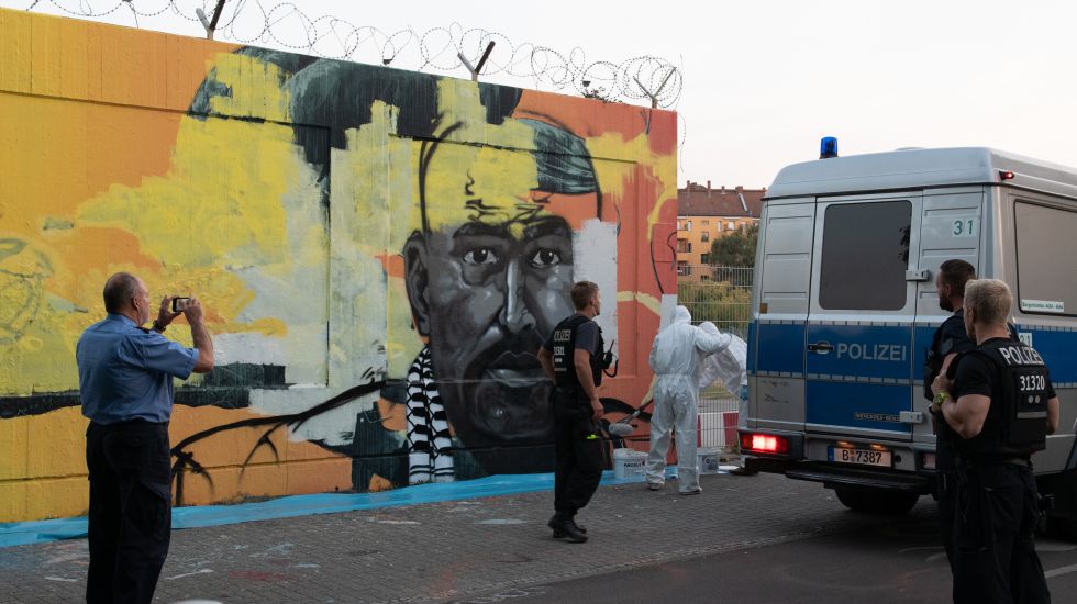 Maler entfernen ein Graffiti am Tatort von Nidal R. 